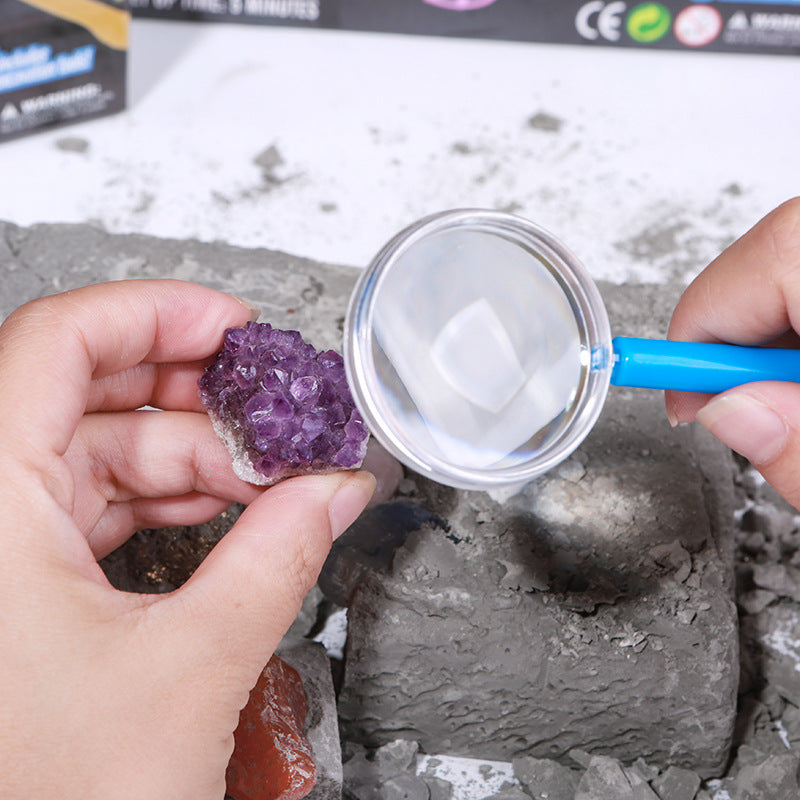 
"Gem Dig STEM Kit — Style C Aquaman themed archaeology set"
"Gem dig kit — child digging out real gemstones"
