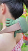 "Velora Wild cordless neck massager full product view — moss green color"
